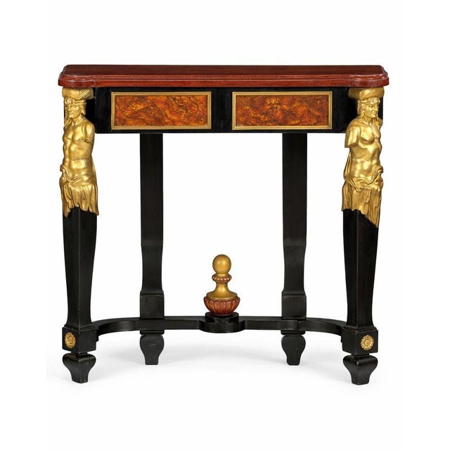 A striking pair of early 19th century Italian neoclassical console tables, executed in ebonized wood with gilt bronze...