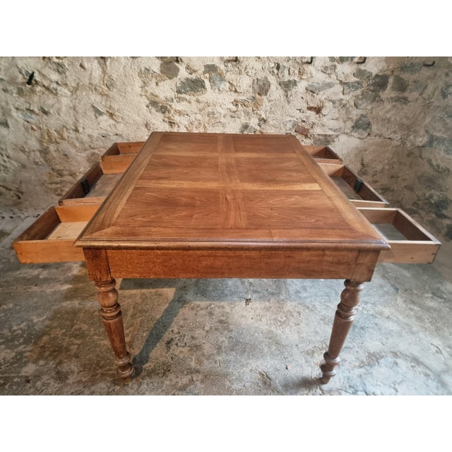 French walnut table dating from the early 20th century. The piece features a balanced and functional design, with six...