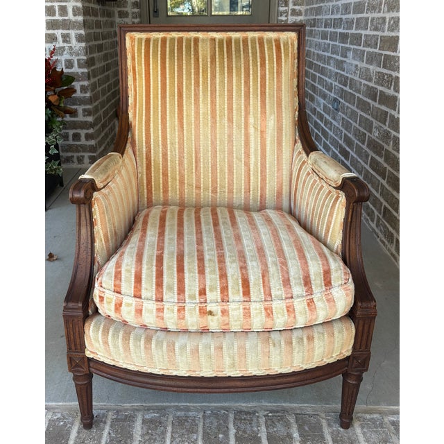 Vintage Louis XVI-style Bergère square back chair that has classic lines with fluted legs, x-motif rosettes, scroll arms...