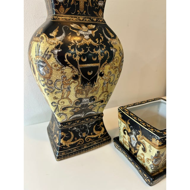 Elegant, decorative tall lidded vessel or urn paired with matching square planter or cachepoi with bottom plate. Black and...