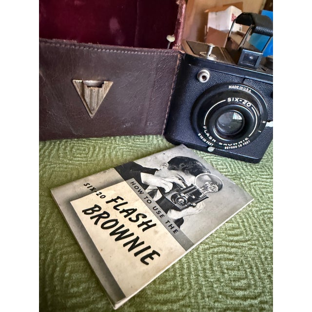 The Kodak Six-20 Flash Brownie with original leather case and instruction manual. It uses 620 roll film and is in working,...