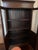 Dark chocolate wood, ring brass handles, clear and perfect glass doors