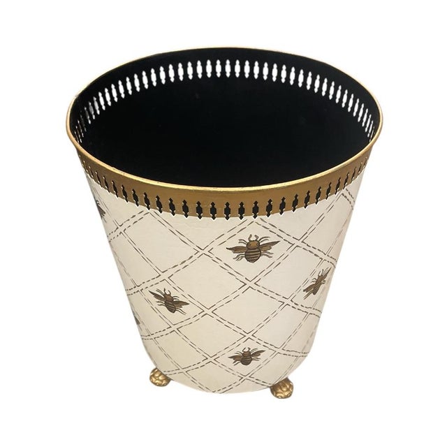 This exquisite metal wastepaper basket. Crafted in the traditional toleware style, this piece features a creamy off-white...