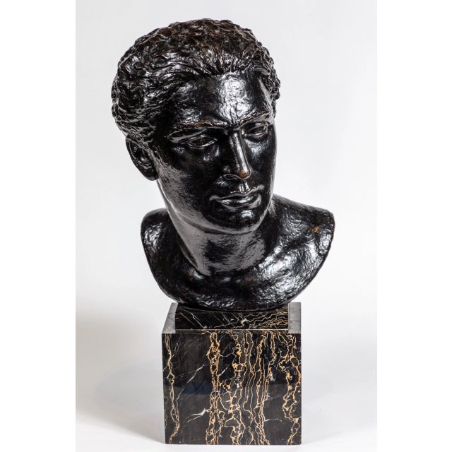 Large, midcentury, cast bronze bust of a man mounted on a chic, veined, polished marble base of the same period.