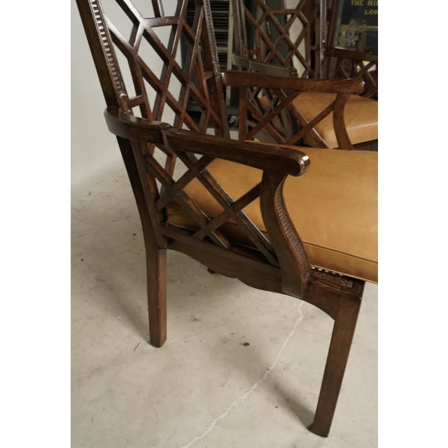 Description: Bob Newhart A Pair of Chippendale style Armchairs with cane seats, and leather seat cushions Provenance: From...