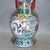 Stunning Chinese famille rose porcelain vase fitted with vibrant red sculpted side handles. The surface features elaborate...