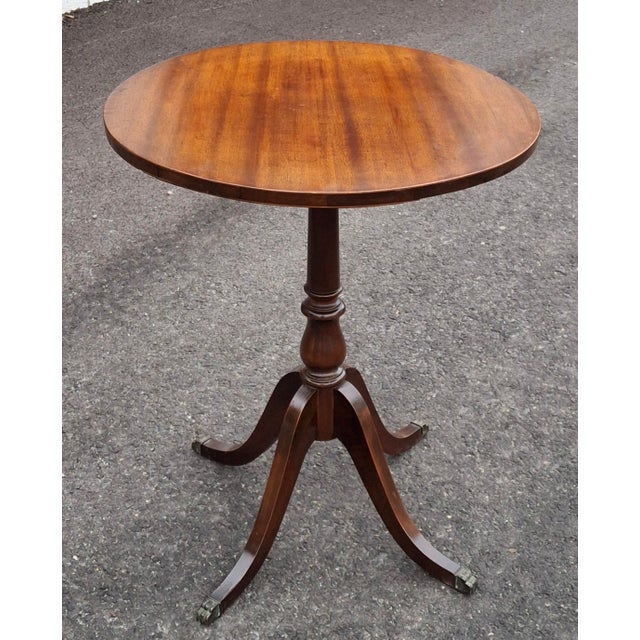 An Early 20th Century George III satin Mahogany pedestal quadpod terminating with brass paw feet in very good antique...