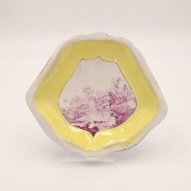 A set of three lozenge shaped dishes decorated in puce and yellow, Continental, circa 1780. Repaired chips.