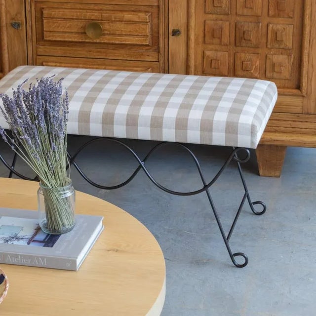 Beautiful iron bench with curved and looped base painted in a matte black finish inspired by French design. Rectangular...