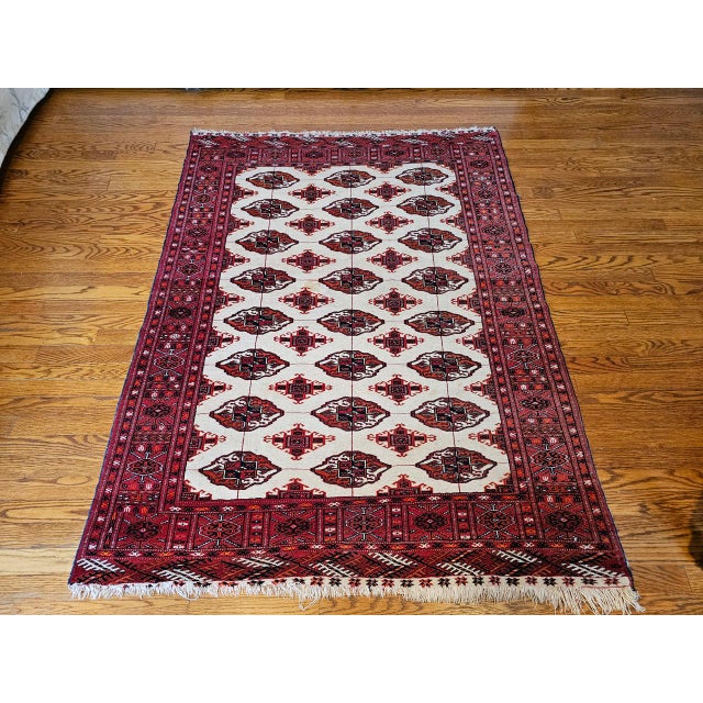 This vintage Turkmen Bokhara area rug, handwoven in the mid-20th century, is a refined and highly desirable example of...