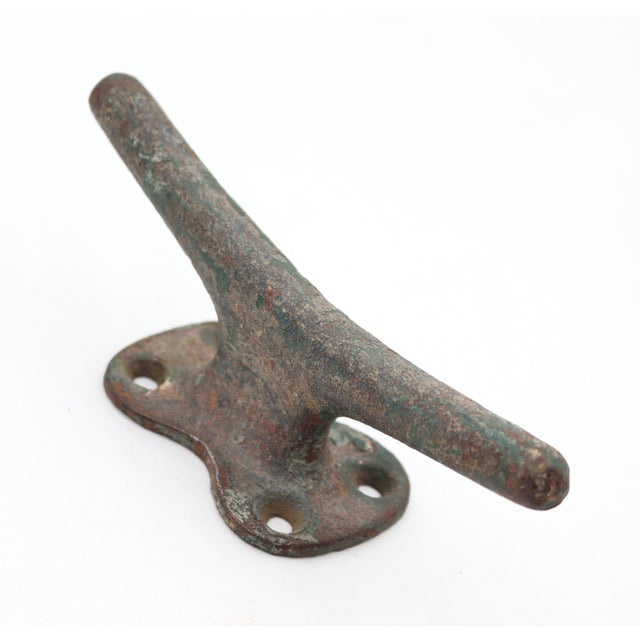 Vintage cleat wall hook made of cast iron with distressed green paint. This style of hook can be used to tie a boat down...
