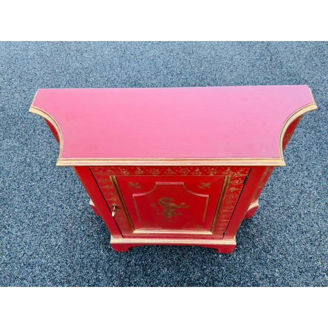 Vintage 1980s red & gold maple wood rounded storage cabinet. This cabinet comes with lots of hand painted detail! The...