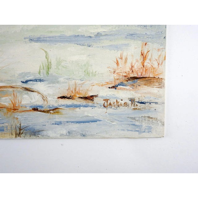 Acrylic on canvas board of a lake and boat in winter. Signed Lackie H lower right corner. Unframed.