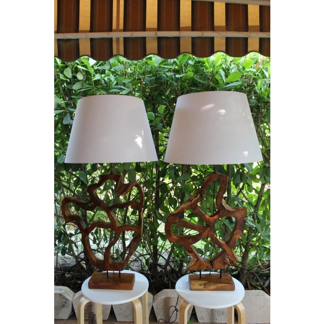 A unusual pair of freeform sculptural lamps. Interesting from all angles. Beautiful polished walnut Because of the hand...