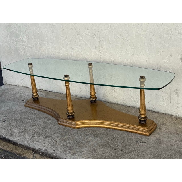 Design Plus Gallery presents a Coffee Table with a Burnished Gold Frame and Tempered Glass Top. The vintage coffee table...