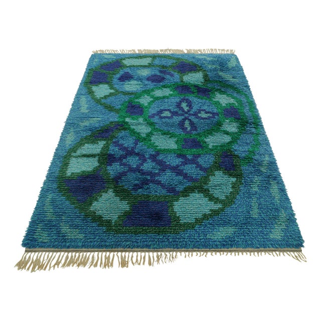 Hand-knotted in lush, high-pile wool in Sweden circa 1960-1970, this 5x7 vintage Swedish Rya rug is a bold new addition to...