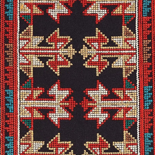 Vinka‚Äôs wide vertical stripes are ornately embroidered with a highly detailed, densely patterned cross-stitching for a...