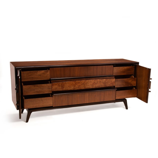 An impressive Hoke Wood Products nine drawer walnut and burl dresser. This sculptural Mid Century lowboy is gorgeous and...