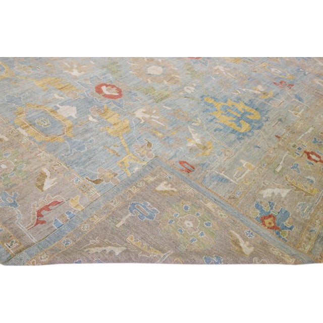Beautiful modern Sultanabad hand-knotted wool rug with a blue field. This Sultanabad rug has a brown frame and multicolor...
