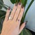 A 0.95-carat blue tanzanite oval sits at the centre of this solid 14K rose gold ring, framed by three earth-mined...