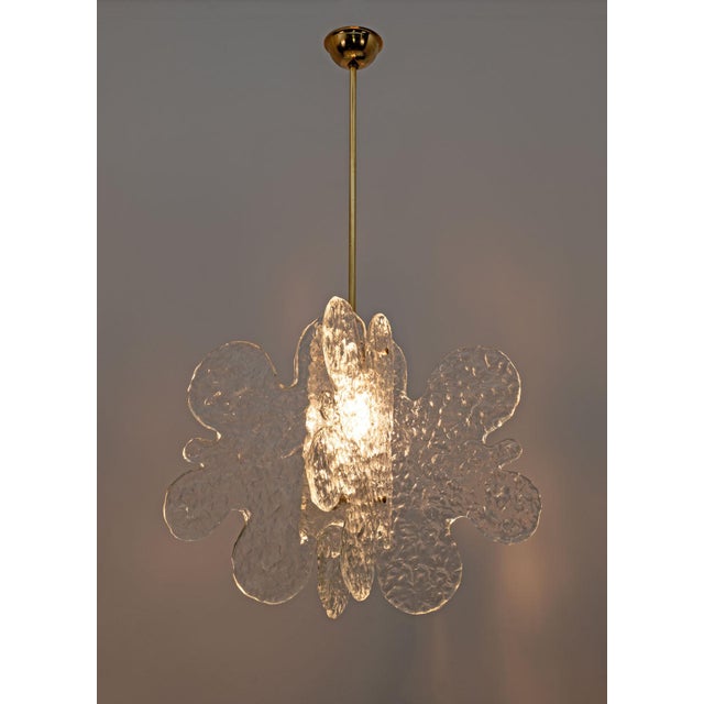 Murano glass chandelier made by Mazzega in the 1970s characterized by four cloud-shaped and structured glass sheets joined...