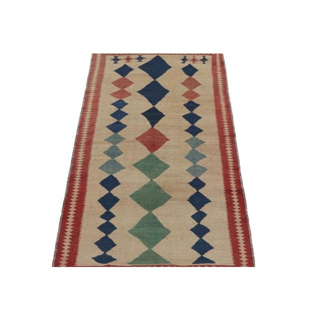 This vintage 4x8 Persian kilim is believed to be a Shahsavan tribal rug. Handwoven in wool circa 1950-1960, its design...