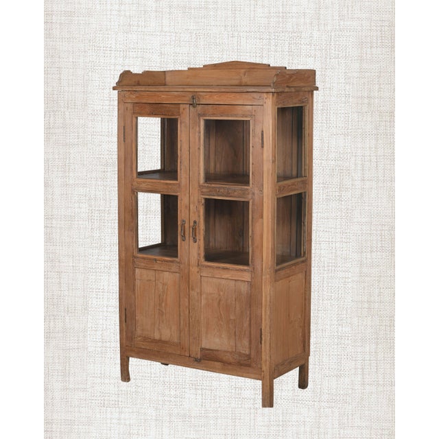 Some pieces don't need scale to make a statement. This compact antique Indian Armoire with bleached teak, glass upper...