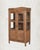 Some pieces don't need scale to make a statement. This compact antique Indian Armoire with bleached teak, glass upper...