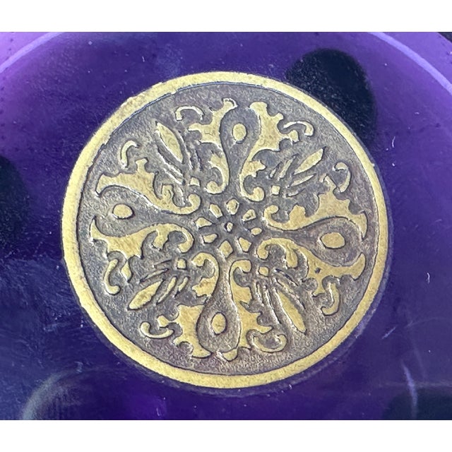 Here we have a super Moser Amethyst Jar with gold gladiators dancing around the circumference , 4 ball feet , 5" wide and...