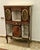 This elegant Louis XV-style display cabinet is a refined statement piece crafted in richly toned wood with exquisite...