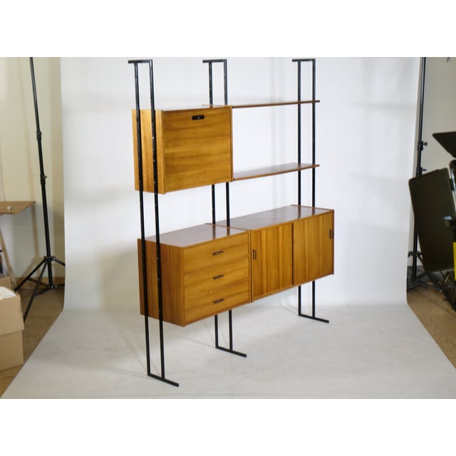 Elegant mid-century shelving system. It's freestanding and can therefore also be used as a room divider. All modules and...