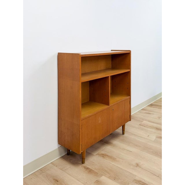 This clean and practical vintage MCM bookshelf with storage cabinet is a well-made and versatile living room or home...