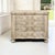 A French Louis XIV commode in stripped oak, with a serpentine facade carved in shell, floral and foliate motifs that flow...
