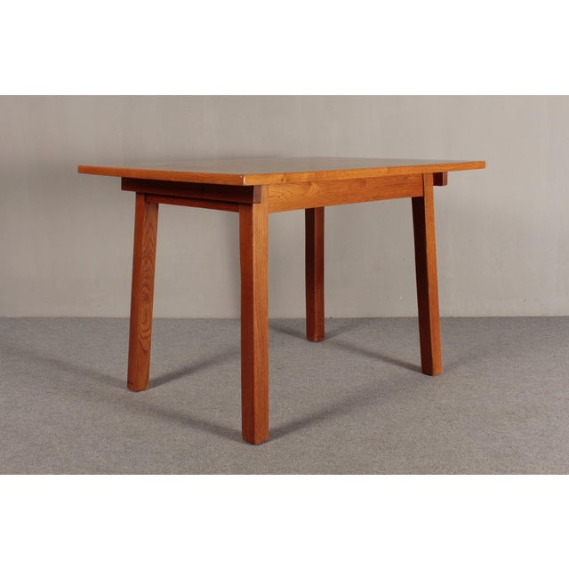 Dining table from southern Germany, made in the 1930s. The table is made of solid oak, stained brown. The tabletop is made...