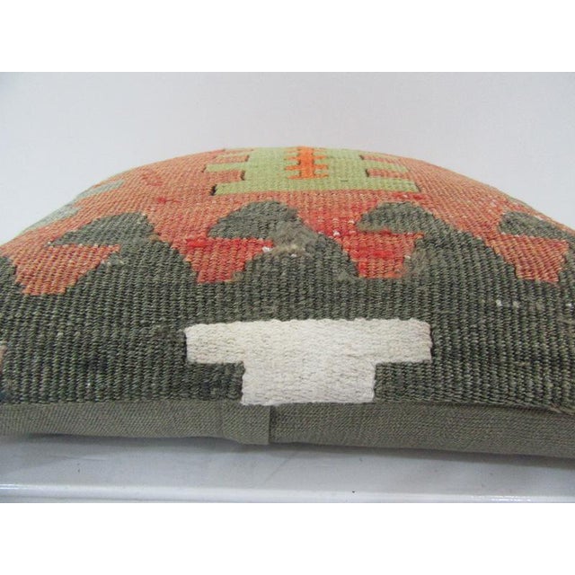 This is a pillow cover made from a vintage kilim rug. The piece was properly washed and ready to use. Pillow inserts not...