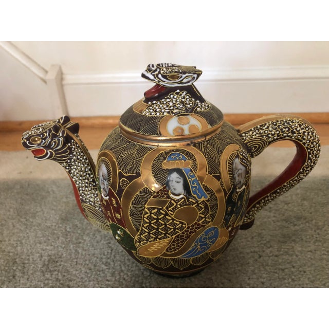 An intricately decorated 13 piece Japanese Dragon ware Moriage Tea Service comprised of a teapot, covered creamer, double-...