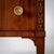 Compact neoclassical chest of drawers with two drawers, bronze fittings and tall tapered legs. The pilaster strips of the...
