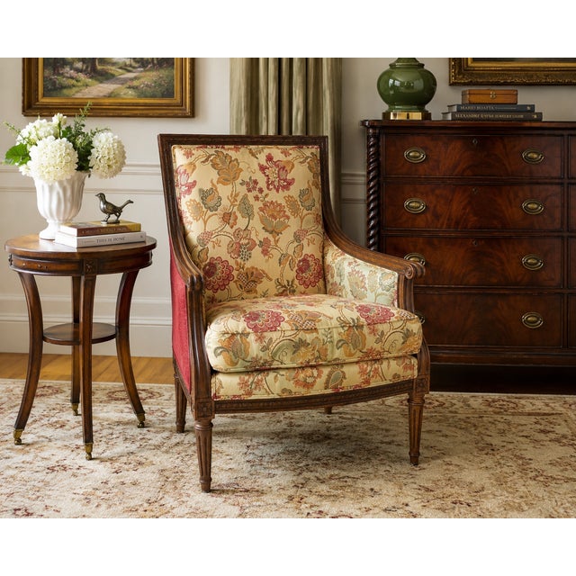 Elegant Ethan Allen bergere-style lounge chair featuring a beautifully carved hardwood frame with neoclassical influences...