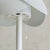 A mid-20th century Italian table lamp, its dome-shaped shade formed from overlapping sheets of perforated white metal. The...