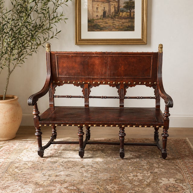 This exquisite leather bench from the late 18th century has been meticulously restored to enhance its sturdiness. The...