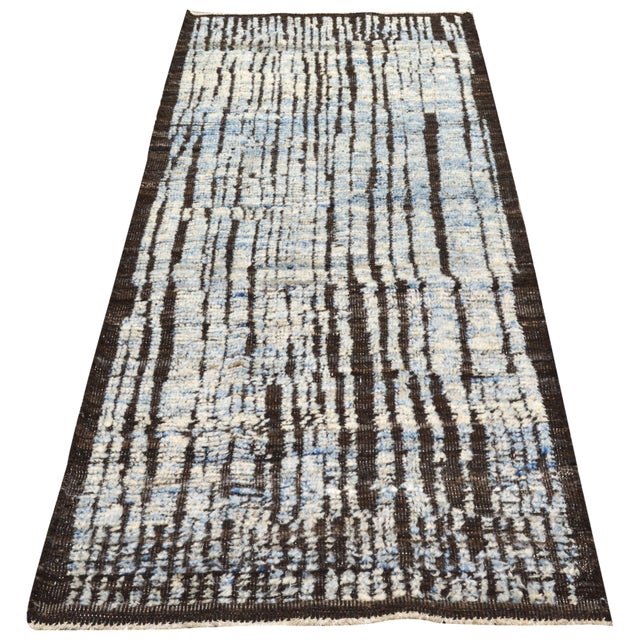 Hand-knotted with care using traditional rug making techniques, this wool rug blends timeless craftsmanship with a modern...