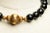An amazing beaded necklace of large, faceted black onyx beads with five graduated melon-shaped 22K gold beads featured at...