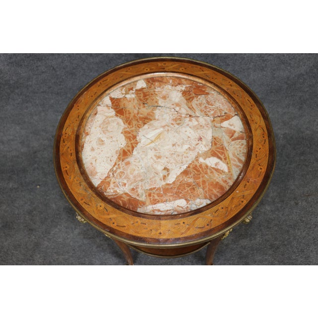 This elegant early twentieth-century French occasional table is a refined example of the Louis XVI Revival style,...