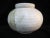 Rustic ceramic jar with lid. Earthy shades of cream and olive green. Signature at base undecipherable. Measures 6" tall x...