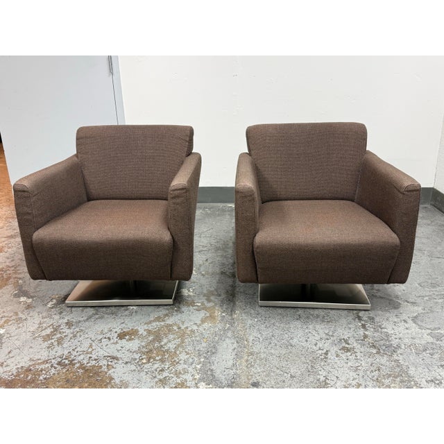 Design Plus Gallery presents a Pair of the Regis Swivel Lounge Chairs from DellaRobbia. Each chair is upholstered in a...