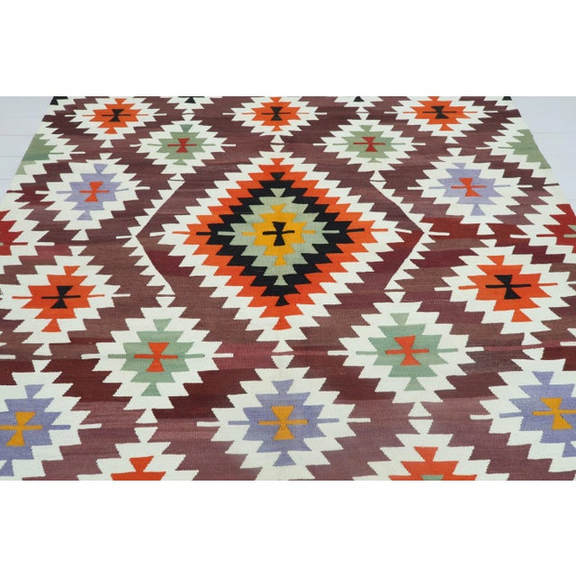 This Turkish Kilim rug hosts an intriguing pallet of vibrant rich and pastel colourways complementing a very Turkish sense...