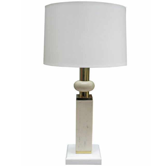 A modernist marble table lamp. White and ivory colored marble with patinated brass details.