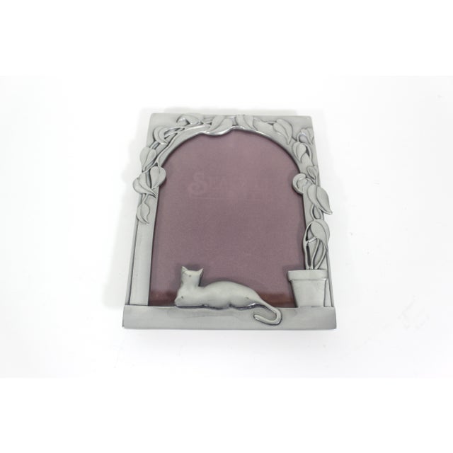 Overall length: 7.5 inches Overall width: 6 inches Large, heavy vintage pewter rectangular frame with cat and potted plant...