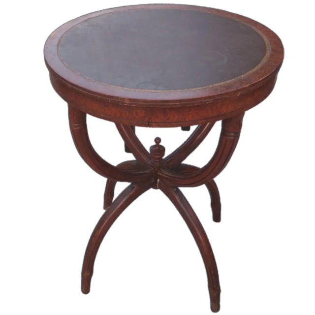 Beautiful gold tooled espresso leather round top as well as mahogany wood are beautifully engaged materials featured on...
