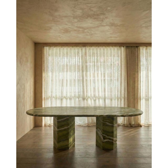 This minimalist table is made from one material, featuring a thick 4cm curved edge top in a beautiful green marble with...